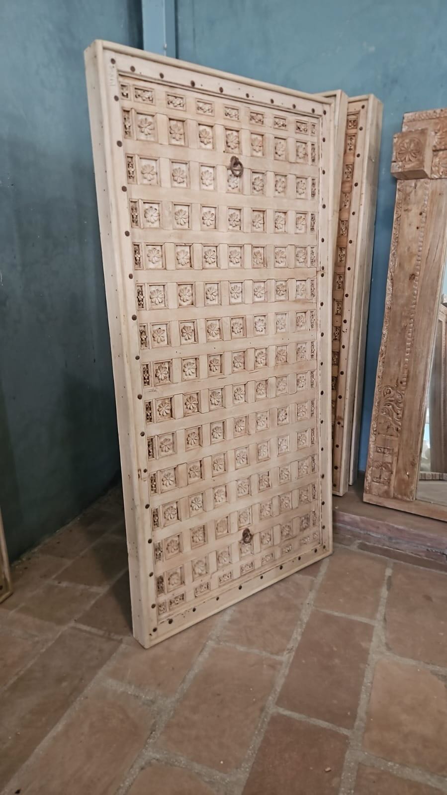 Bhuvi hand-carved teak headboard made from an old Indian ceiling door, featuring symmetrical floral panels and a whitewashed finish—an heirloom-style piece of old door headboards and old Indian door furniture.