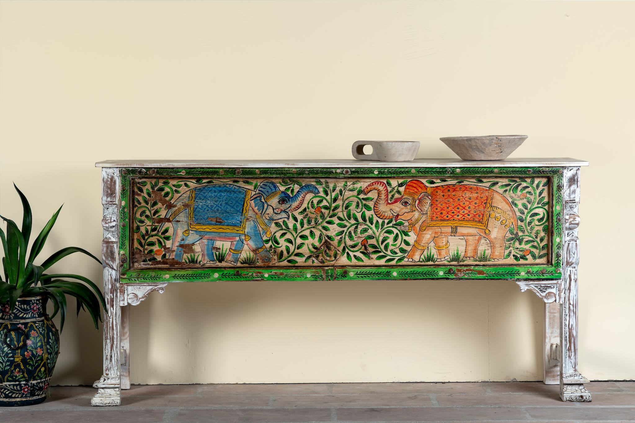 Hand-painted console table Caara made from reclaimed wood with vibrant elephant motifs and green foliage. A unique furniture piece full of vintage flair for bohemian interiors.