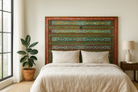 Lifestyle image of a Cauvery hand painted head board made from an antique Indian teak door, featuring traditional floral motifs in blue and cream and original iron hardware—an elegant example of hand painted head boards and authentic Indian headboards.