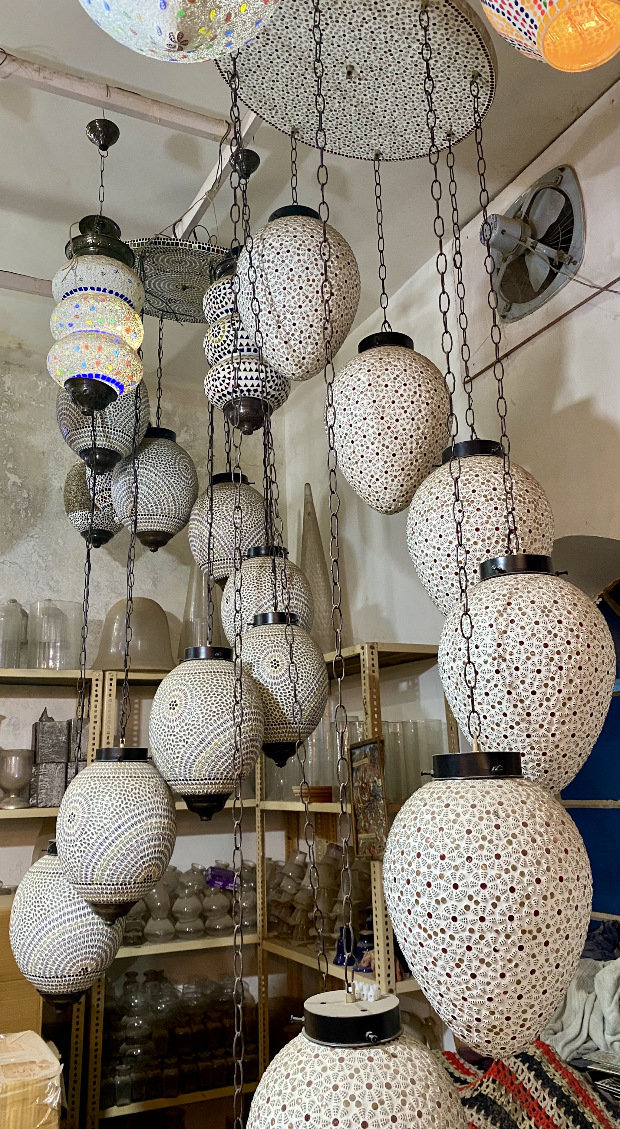 Decorative hanging lights with textured design in a store setting