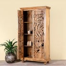 Open door image of a hand-carved mango wood cupboard with Indian peacock design motifs, Mediterranean-style wardrobe; elegant mango wood furniture, 190 × 100 × 40 cm.