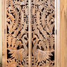 Close up image of a hand-carved mango wood cupboard with Indian peacock design motifs, Mediterranean-style wardrobe; elegant mango wood furniture, 190 × 100 × 40 cm.