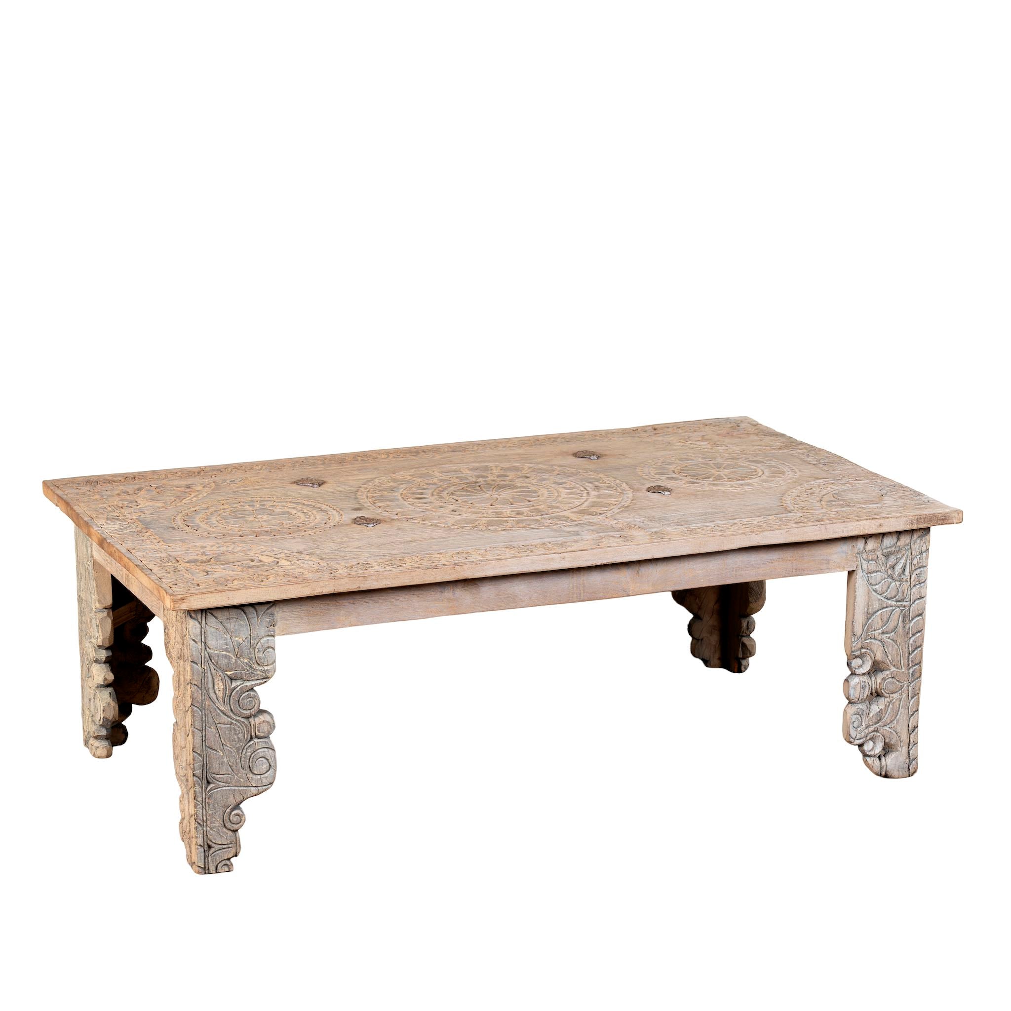 White background image of a sandblasted reclaimed teak wood coffee table with carved antique Indian door top; unique teak wood furniture and living room furniture, 140 × 40 × 48 cm.