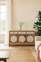 Lifestyle imagination o a hand carved wooden sideboard made from mango wood with floral carvings and curved base, mango wood furniture with storage, 150 × 40 × 95 cm.