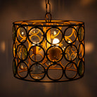 Image with a lighted round unique pendant light with shiny brass-plated iron frame and magnifying glass inserts – vintage lighting with elegant three-light design for kitchens, dining areas, or living rooms.