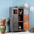 Side angle image with open door of a shabby chic teak wood cabinet with glass doors and natural reclaimed finish – sustainable furniture ideal for vintage-style dining and living spaces.