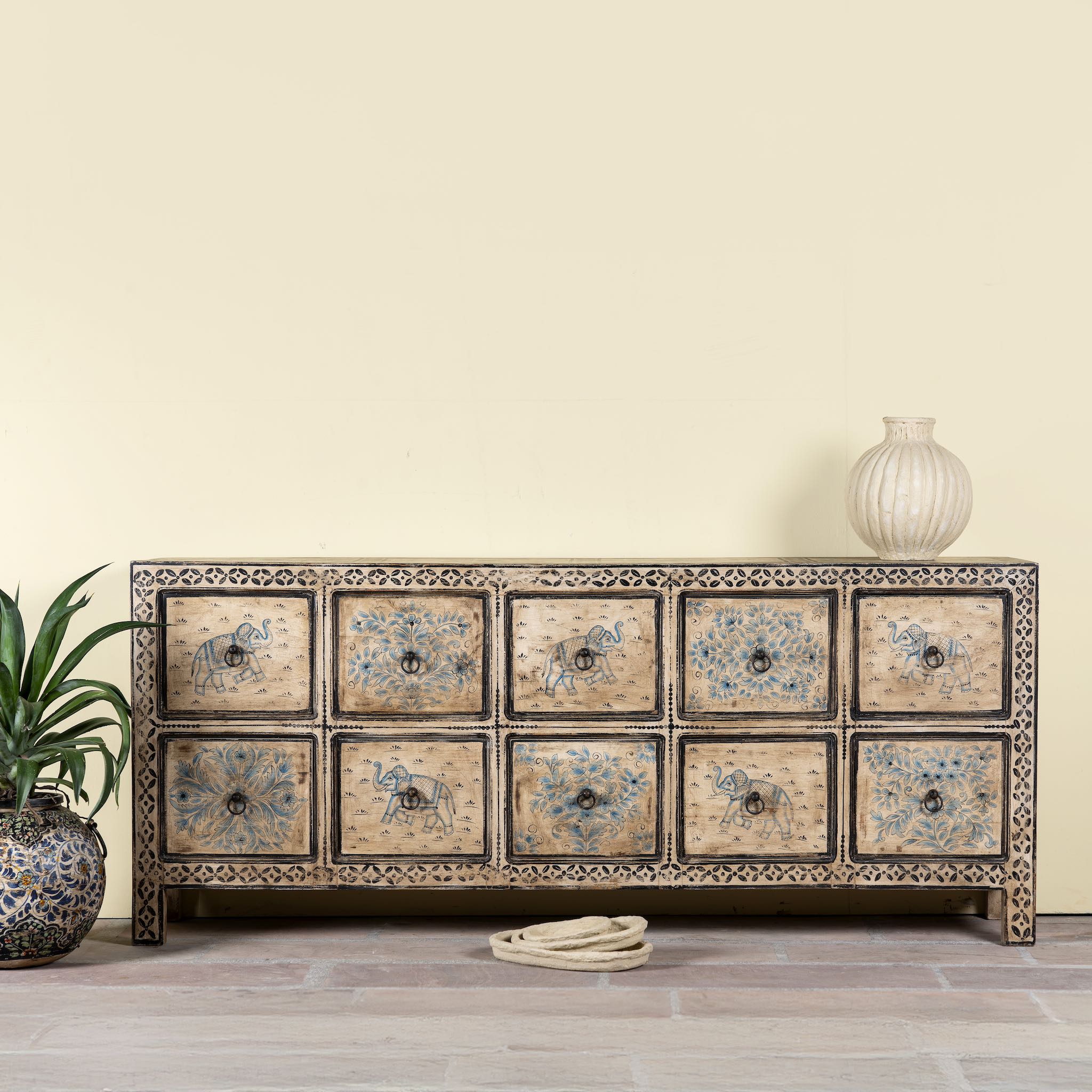 Hand painted mango wood chest of 10 drawers with elephant and floral motifs; hand painted furniture for a boho chic living room, 200 × 41 × 85 cm.