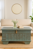 Liefestyle image of a antique Indian chest coffee table in blue with brass fittings – iron fitted wooden chest made from solid teak, ideal for living rooms with storage space.