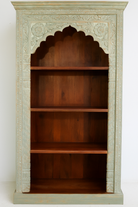 White background image of a hand-carved mango wood bookcase with Mediterranean design and open shelving – mango wood shelving and hand carved wooden furniture with natural finish.