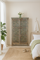 Lifestyle imagination of a reclaimed wood cabinet with floral and geometric designs, perfect for a bohemian interior with Mediterranean style.