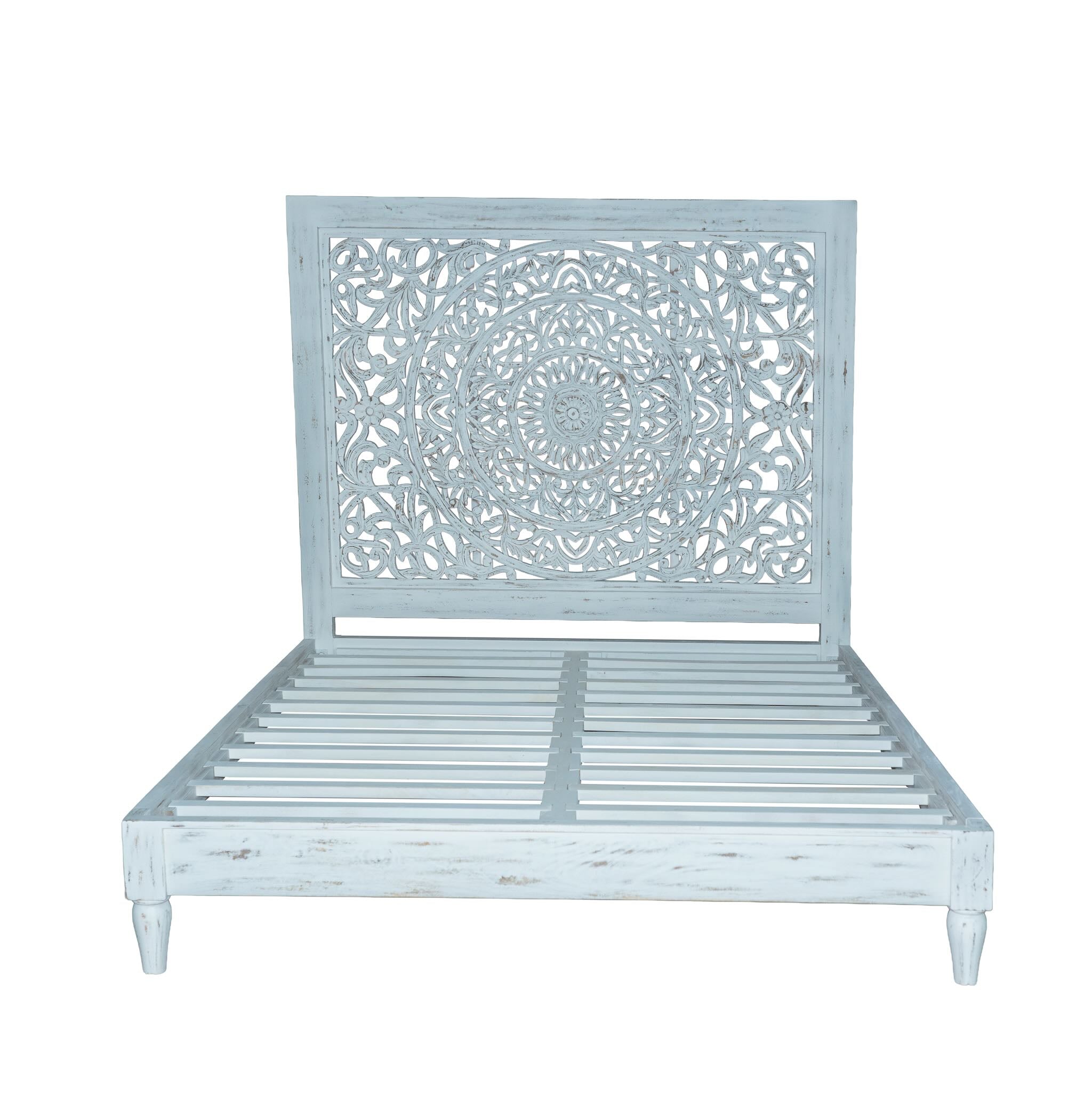 White background image of a hand-carved wooden bed made of mango wood with large floral panel in white finish – Flair model by Om Home & Garden