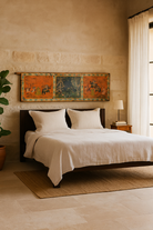 Lifestyle image of a hand-painted Indian wall panel made from reclaimed teak wood door with royal and animal motifs; unique wall panel in boho style décor, 208 × 4 × 55 cm.