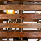 Close up image of a multi-ring rustic pendant lamp made of mango wood with brass accents – a minimalistic style lighting piece ideal for dining areas, kitchens, or stylish open spaces.