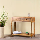 Side angle image of a Ibiza style reclaimed wood console table with two drawers and bottom shelf, warm natural finish, 100 × 40 × 90 cm.