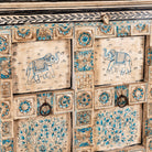 Close up image of a hand-painted cupboard made from reclaimed wood and old Indian doors – a sustainable furniture piece perfect for Indian home decor and rustic interiors.
