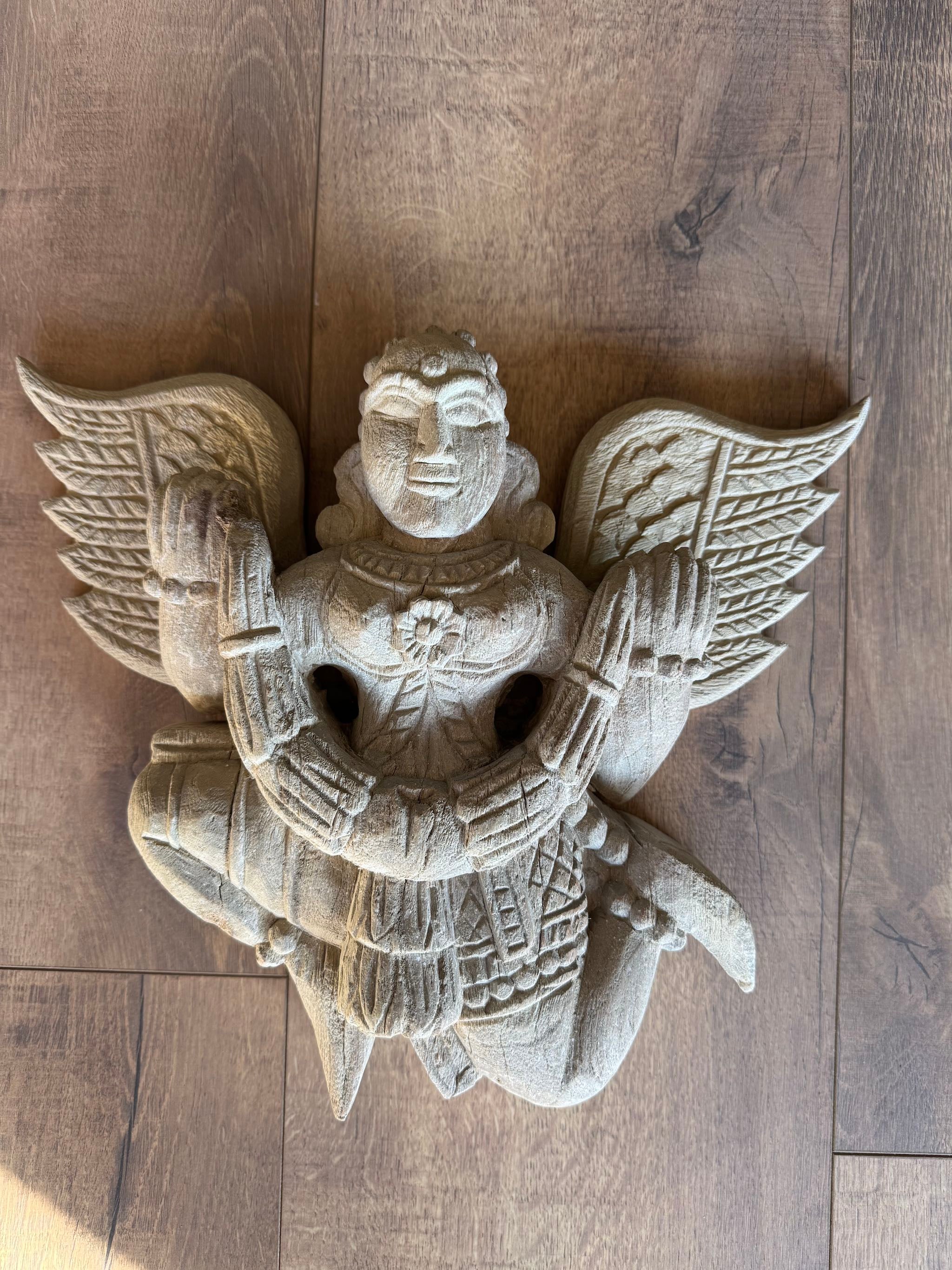 Hand-carved Indian deity wall sculpture with wings, made from reclaimed wood with sandblasted finish – spiritual wall decoration, 30x40x5cm.