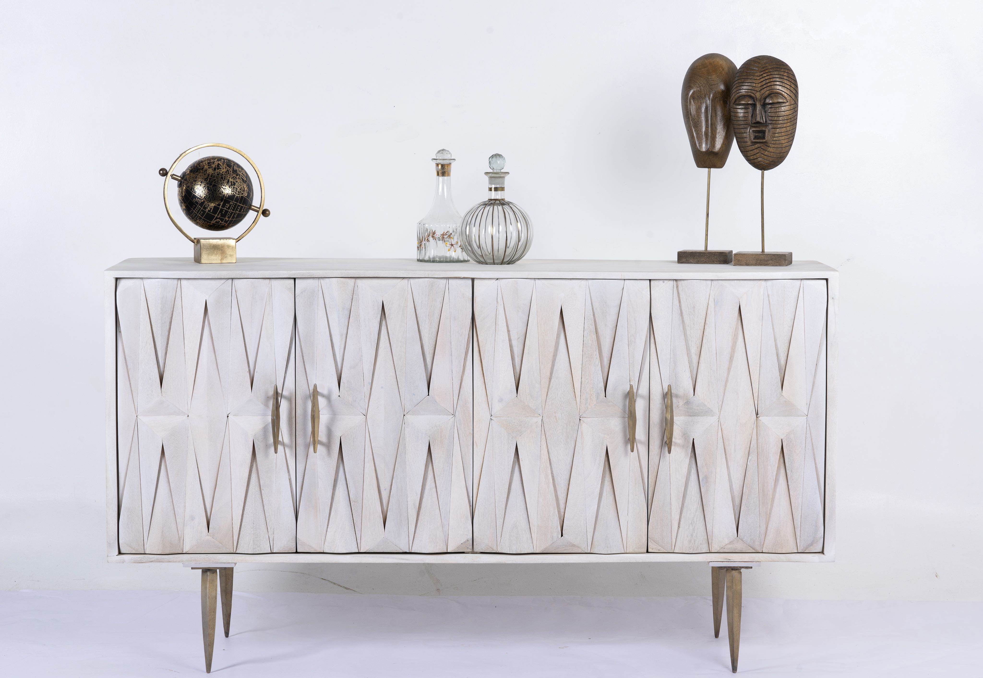 Whitewashed mango wood sideboard with raised criss-cross design, four doors, and silver metal legs—elegant living room furniture with modern rustic appeal.