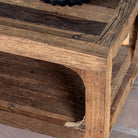 Close up view of a coffee table made of reclaimed wood in Wabi Sabi style decorated in a living room scene.