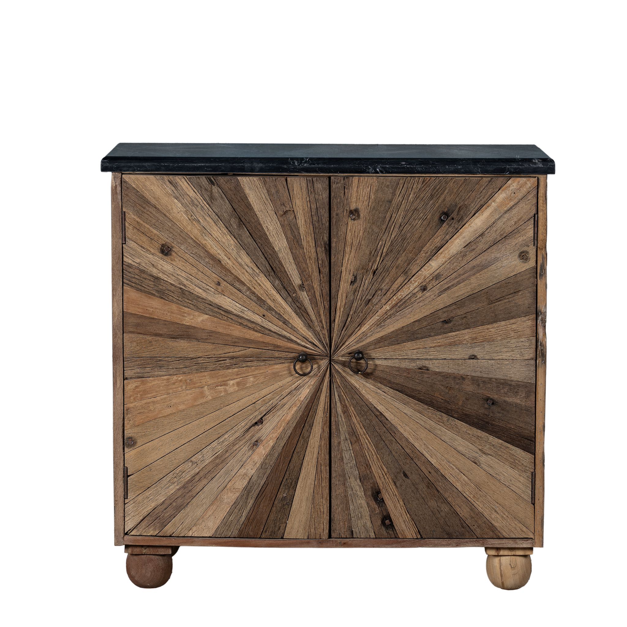 White background image of a rustic-style cabinet made from reclaimed wood, featuring a striking sunburst pattern on the double doors, round metal pulls, and a contrasting black marble top that adds a refined touch to its natural, weathered look.
