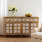 Lifestyle imagination of a  hand-carved mango wood sideboard with whitewashed floral details; perfect as living room furniture or mango wood furniture for vintage interiors, 180 × 100 × 40 cm.