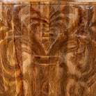 Close up view of a elegant round hand carved coffee table made of sustainable Mango wood with floral design.