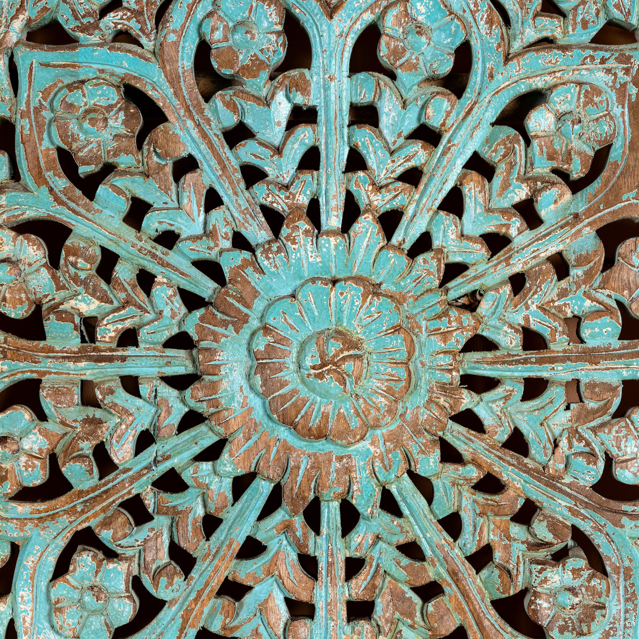 Close up image of a hand-carved mango wood wall panel with floral motifs in blue finish – Kataee Blue model by Om Home & Garden