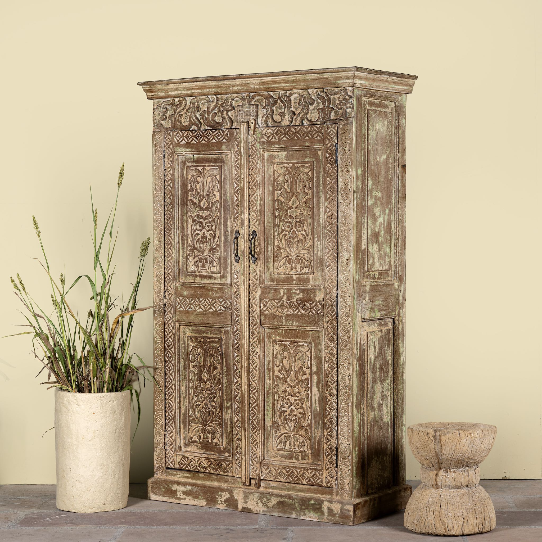 Side angle image of a hand-carved reclaimed wood wardrobe with vintage finish – a sustainable furniture piece ideal for Indian home decor and rustic interiors.