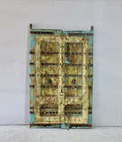 Hand-painted old Indian teak door shabby blue yellow with original handles in vintage style.