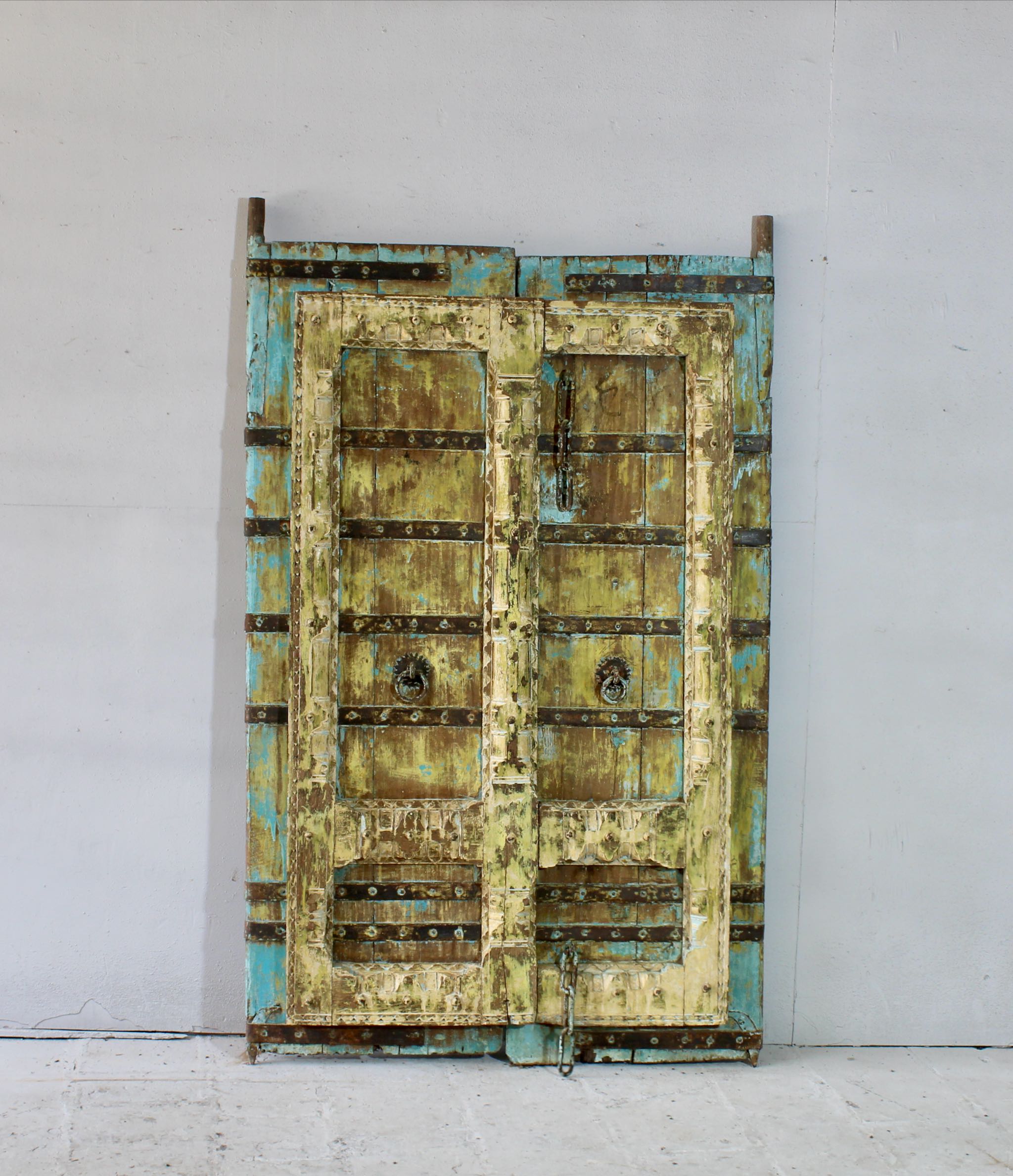 Hand-painted old Indian teak door shabby blue yellow with original handles in vintage style.