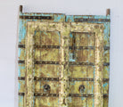 Hand-painted old Indian teak door with shabby blue yellow in vintage style.