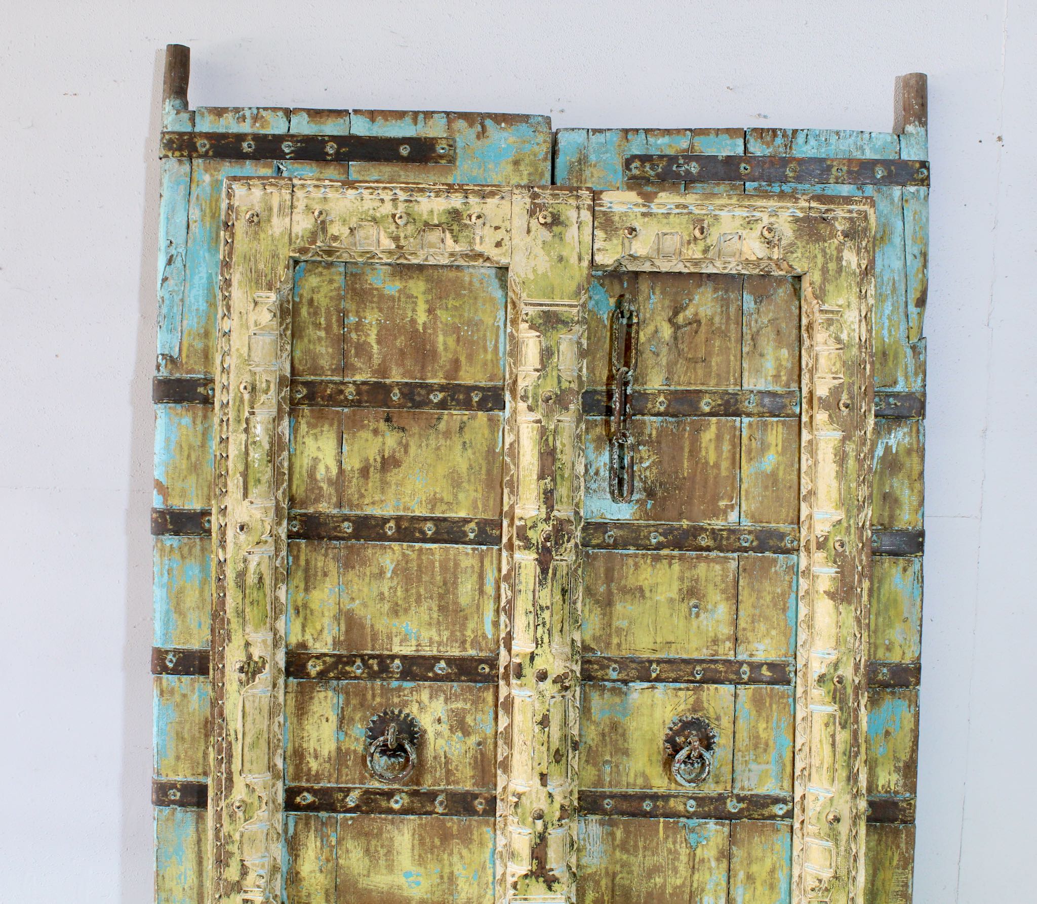 Hand-painted old Indian teak door with shabby blue yellow in vintage style.
