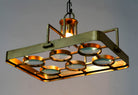 Image showing a lighted unique pendant light with brass-plated iron square frame and magnifying blue and white glass inserts – vintage lighting piece ideal for kitchens, living rooms, or entryways.