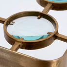 Close up image of a unique pendant light with brass-plated iron square frame and magnifying blue and white glass inserts – vintage lighting piece ideal for kitchens, living rooms, or entryways.