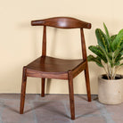 Side angle image of an acacia wood chair with sculptural backrest, minimalist wooden armchair for dining or living rooms, 50 × 50 × 90 cm.