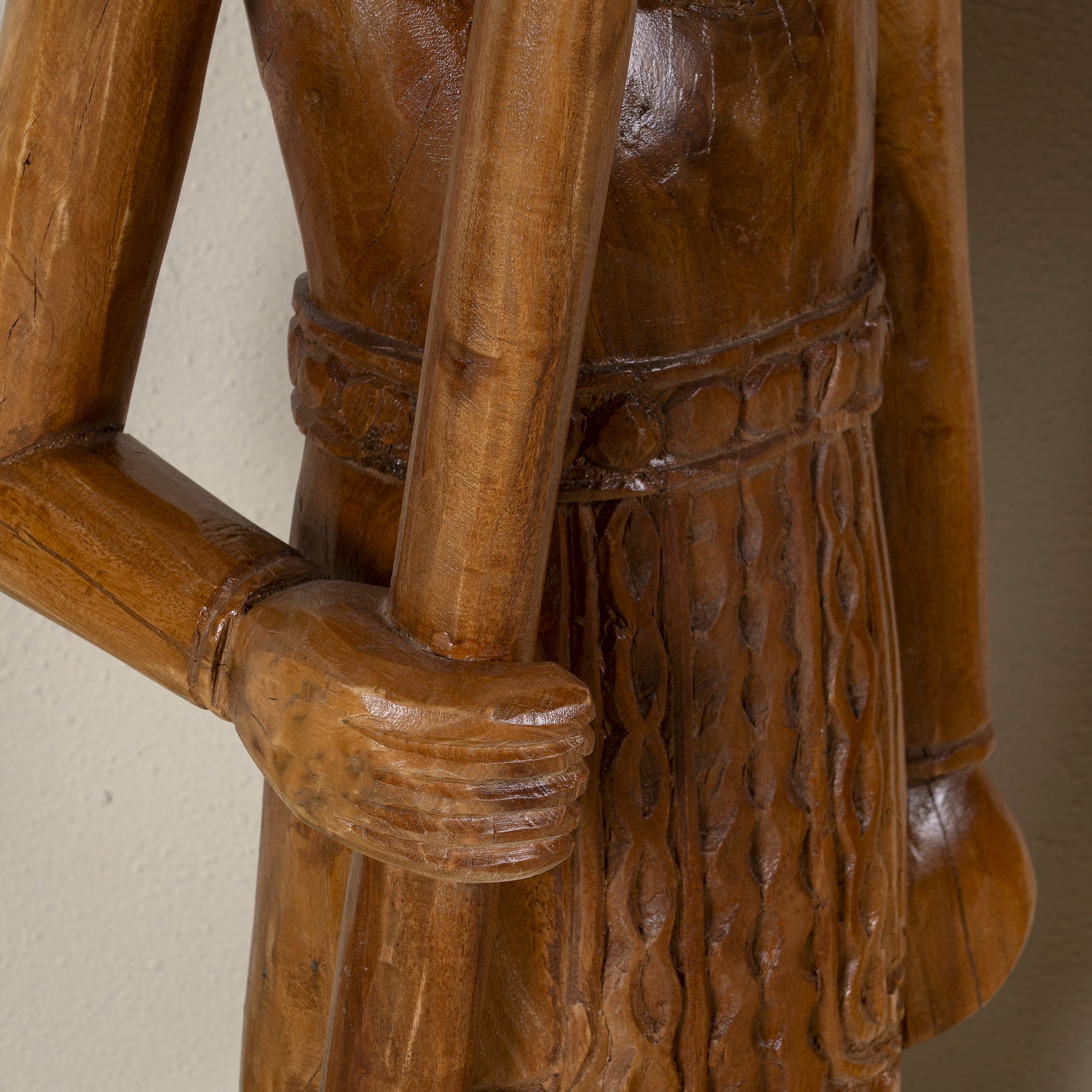 Close up image of a hand-carved Indian house guardian statue in exotic style, made from reclaimed wood; sustainable furniture, 40 × 20 × 120 cm.
