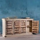 Open door view of a unique old Door sideboard, finely hand carved in bleached teak wood driftwood design.