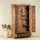 Open door view of a hand carved mango wood cabinet with floral design, 2 doors and one drawer in vintage design.