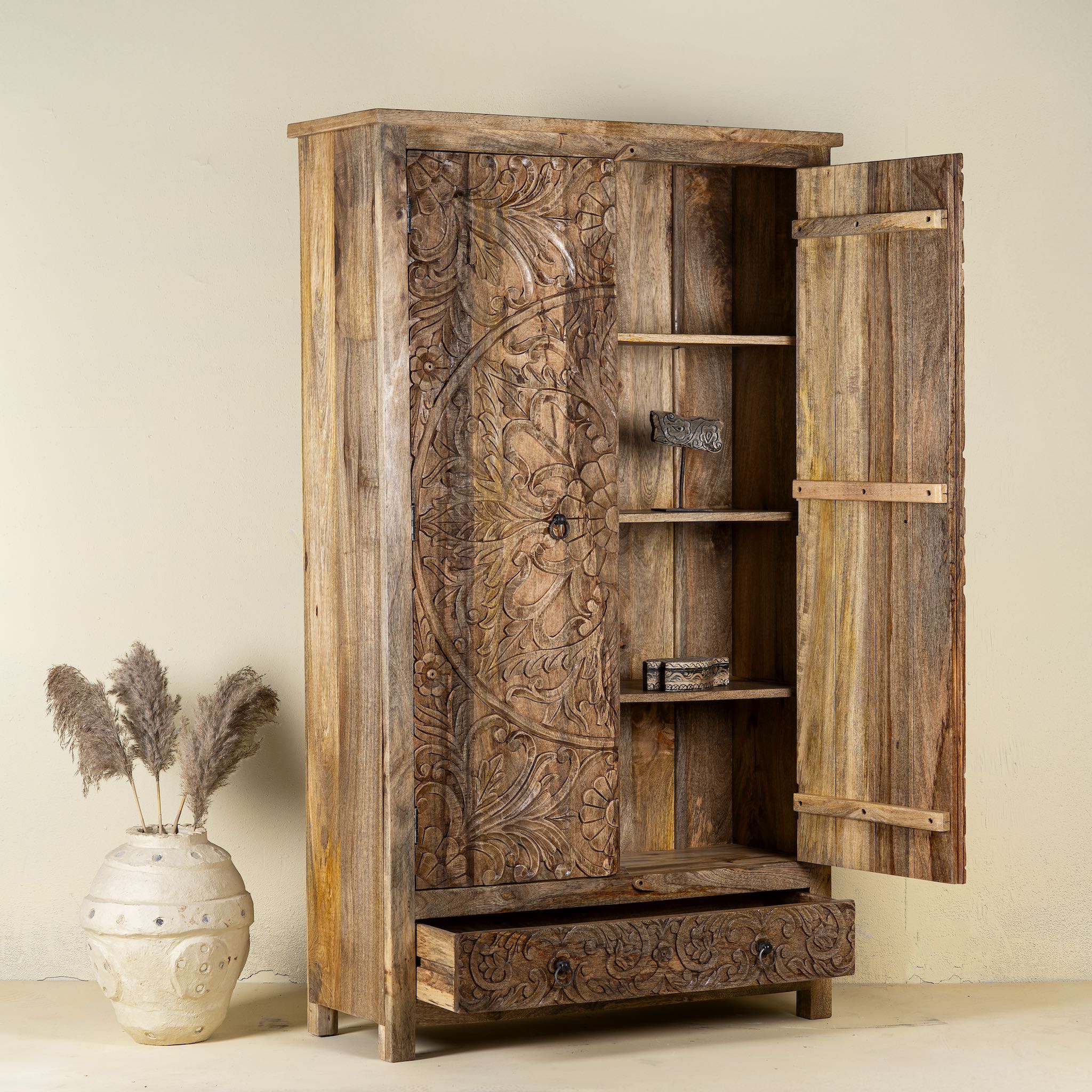 Open door view of a hand carved mango wood cabinet with floral design, 2 doors and one drawer in vintage design.