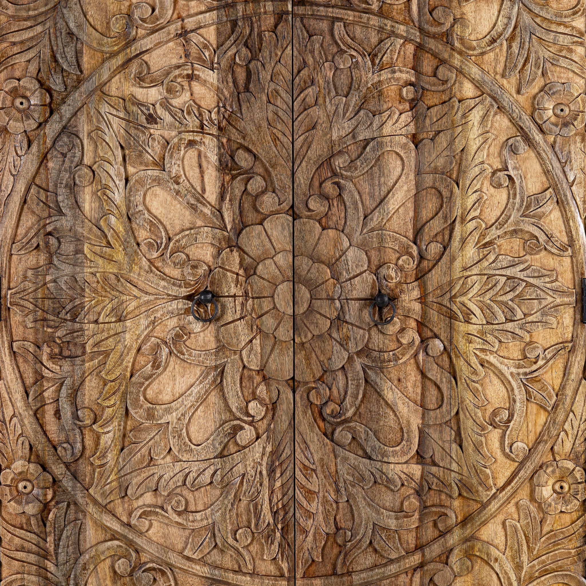 Close up view of a hand carved mango wood cabinet with floral design, 2 doors and one drawer in vintage design.