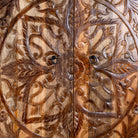 Close up image of a hand-carved mango wood wardrobe, a unique wooden furniture piece inspired by traditional Indian furniture craftsmanship.