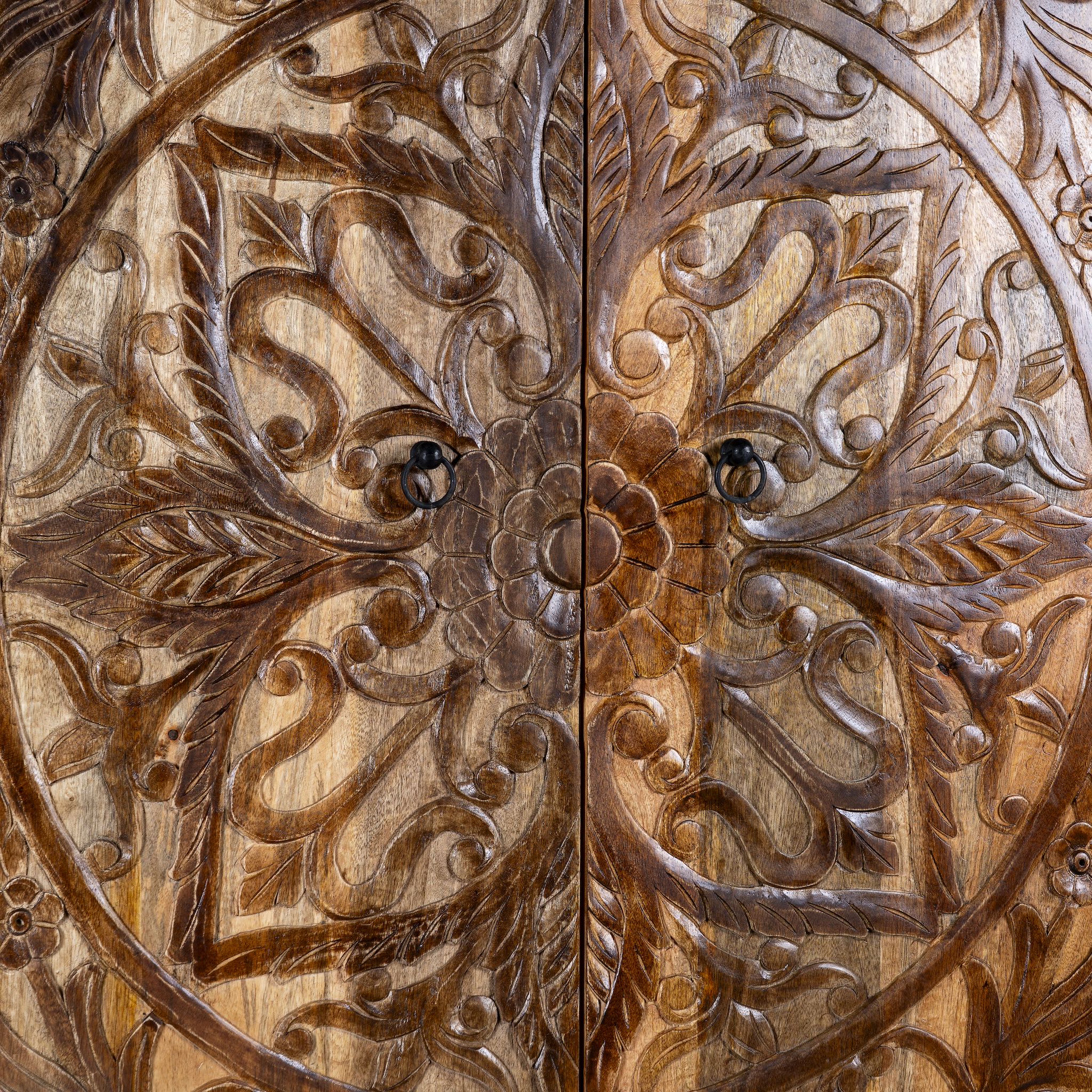 Close up image of a hand-carved mango wood wardrobe, a unique wooden furniture piece inspired by traditional Indian furniture craftsmanship.