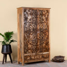 Side angle image of a hand-carved mango wood wardrobe, a unique wooden furniture piece inspired by traditional Indian furniture craftsmanship.