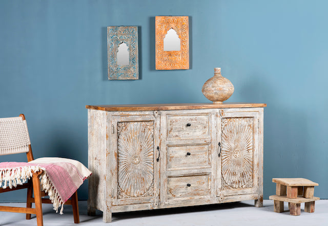 Sde angle image of a handcrafted carved sideboard made from solid mango wood with floral motifs, antique layered finish, and natural wood top; artisan vintage furniture, 150 × 40 × 90 cm.