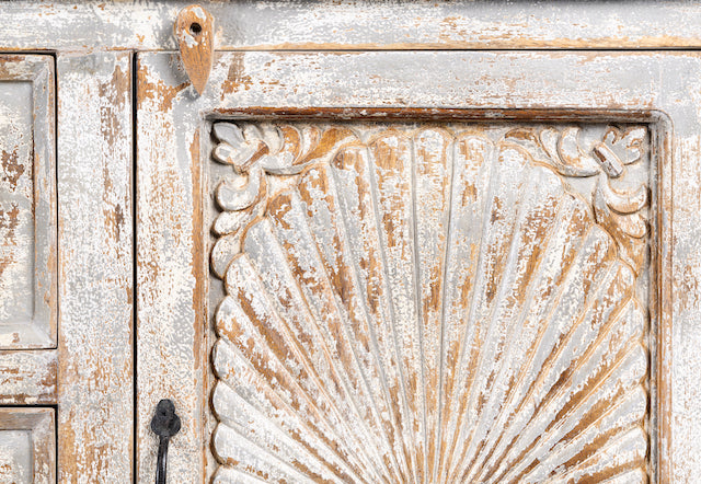 Close up image of a handcrafted carved sideboard made from solid mango wood with floral motifs, antique layered finish, and natural wood top; artisan vintage furniture, 150 × 40 × 90 cm.