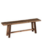 White background image of a rustic wooden bench made from reclaimed wood, featuring a long, narrow seat with a weathered finish and sturdy angled legs connected by a simple support beam.
