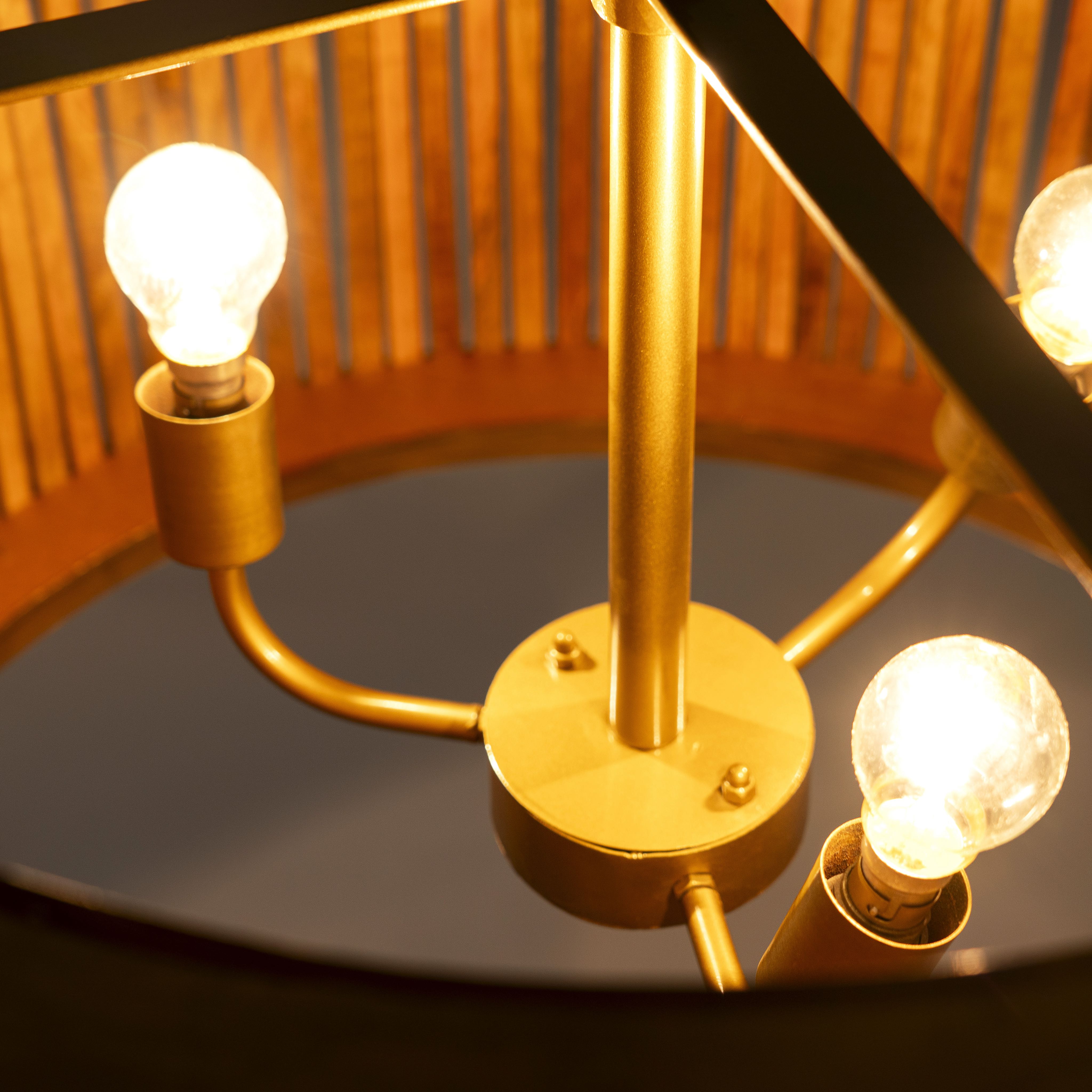 Close up image of a large rustic pendant lamp made of natural mango wood with brass-clad edges – minimalistic style lighting ideal for dining rooms, kitchens, or spacious living areas.