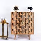Artisanal mango wood cabinet with natural doors, black frame, and brass knobs, 91 × 113 × 41 cm.