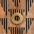 Close up image of a artisanal mango wood cabinet with natural doors, black frame, and brass knobs, 91 × 113 × 41 cm.