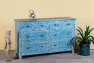 Side angle image of a hand-painted chest of drawers made of reclaimed wood in blue and white – Nitara model by Om Home & Garden