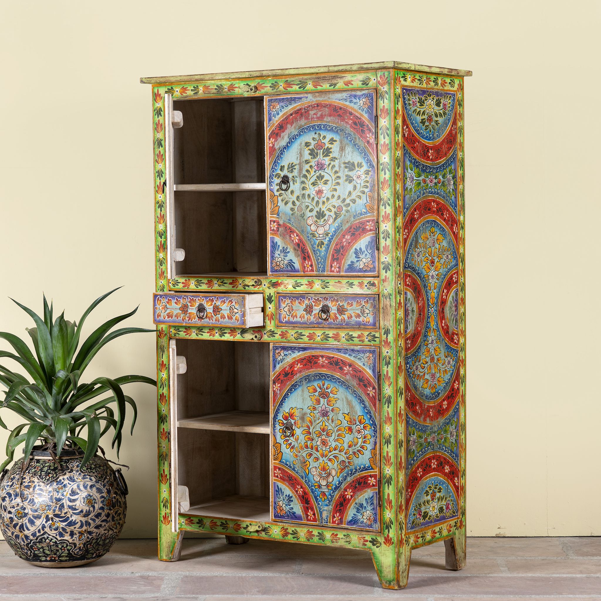 Side angle image showing open door of a Hand-painted cabinet made from reclaimed wood with colourful floral motifs – a sustainable furniture piece ideal for expressive Indian home decor.